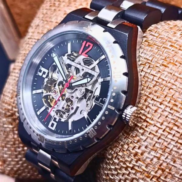 Montre artisanale en bois automatique Manège pour homme pose sur un coussin
